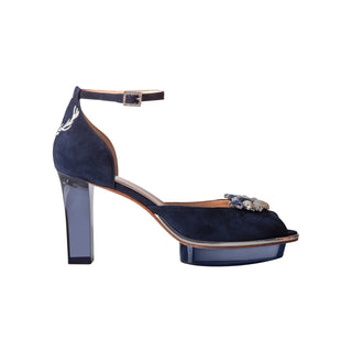 Ein magischer nachtblauer Peeptoes Riemchenpump von der Firma Cinderella’s by Marcela aus Wildleder mit einer wunderschönen Hirschgeweihstickerei sowie hochwertigem transparenten / durchsichtigen Absatz und Plateau. Die Schuhe sind mit silbernen Accessoires verziert, und die Schnalle ist mit funkelnden Steinchen veredelt. Perfekt geeignet für alle gehobene Trachtenevents. 